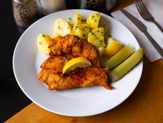 Popular Czech dish of fried chicken fillet in batter with Parmesan served with boiled potatoes and...