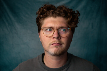 Man with Glasses Confused Portrait with Blue Background.