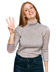 Young irish woman wearing casual clothes showing and pointing up with fingers number three while smiling confident and happy.