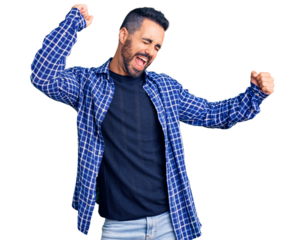Young hispanic man wearing casual clothes dancing happy and cheerful, smiling moving casual and confident listening to music