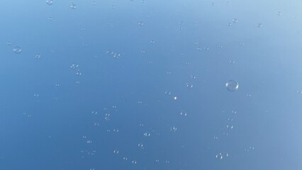 Bubbles floating in the clear blue sky 