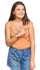 Young caucasian woman wearing casual clothes cheerful with a smile of face pointing with hand and finger up to the side with happy and natural expression on face