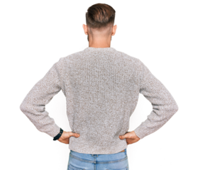 Young redhead man wearing casual winter sweater standing backwards looking away with arms on body