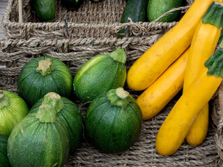 yellow and green zucchini in a farmers market stall
