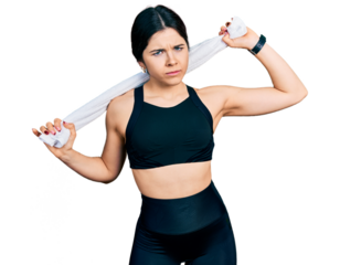 Young brunette woman with blue eyes wearing sportswear and towel skeptic and nervous, frowning upset because of problem. negative person.