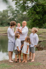 Fototapeta premium large family walks near the lake in the summer