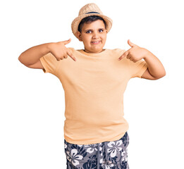 Little boy kid wearing summer hat and hawaiian swimsuit looking confident with smile on face,...