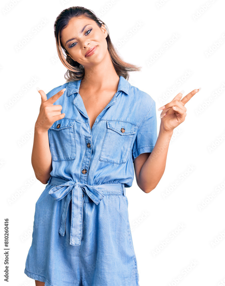 Sticker young beautiful woman wearing casual clothes smiling and looking at the camera pointing with two han