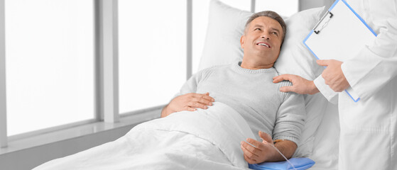 Doctor telling good news to mature man in clinic