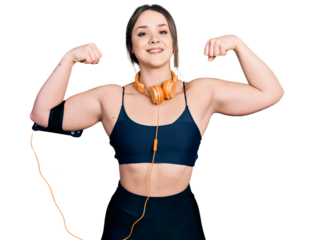 Young hispanic girl wearing sportswear doing strong gesture smiling with a happy and cool smile on face. showing teeth.