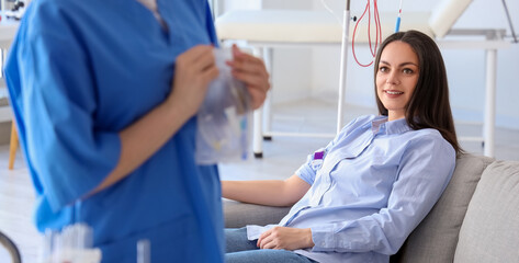 Young woman donating blood in clinic