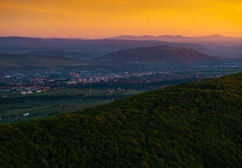 Sunrise over Odorheiu Secuiesc city in Transylvania. Aerial photo with Odorheiu Secuiesc and a...