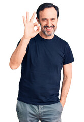 Middle age handsome man wearing casual t-shirt smiling positive doing ok sign with hand and fingers. successful expression.