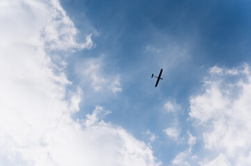 Unmanned military drone flying in the sky above the clouds, technology. Concept: military reconnaissance drone, incident in the sky, war in Ukraine.