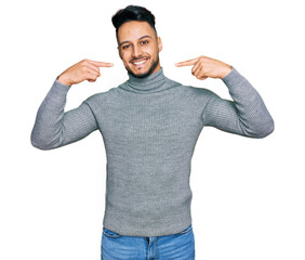 Young arab man wearing casual clothes smiling cheerful showing and pointing with fingers teeth and mouth. dental health concept.
