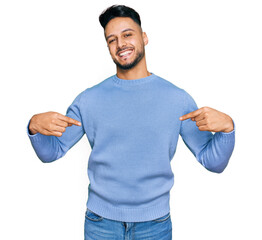 Young arab man wearing casual clothes looking confident with smile on face, pointing oneself with...