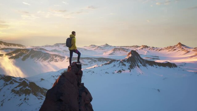 Aerial Around Young Hiker Man Standing on Mountain Peak Summit At Sunset Sunrise Expedition Challenge Drone Epic Adversity Conquering Fear Anxiety Concept CG