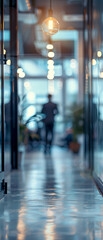 Fototapeta premium Startup, office and person in workplace with lightbulb, opportunity and idea for business. Corporate, space and light in hall with employee walking on floor with inspiration, energy or power