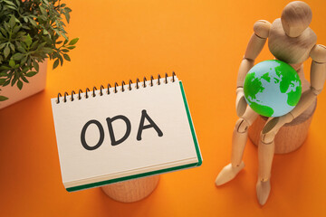 There is notebook with the word ODA. It is an abbreviation for Official Development Assistance as eye-catching image.