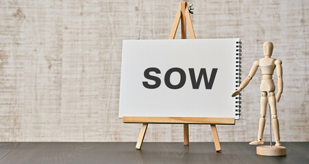 There is notebook with the word SOW. It is an abbreviation for Statement Of Work as eye-catching image.