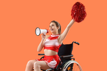 Young cheerleader in wheelchair with megaphone on orange background