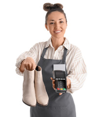 Happy female shoemaker with badge holding shoes and payment terminal on white background