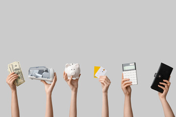 Female hands with piggy bank, cash counting machine, money and calculator on grey background