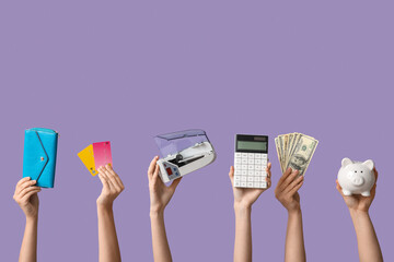 Female hands with cash counting machine, money, piggy bank and credit cards on color background