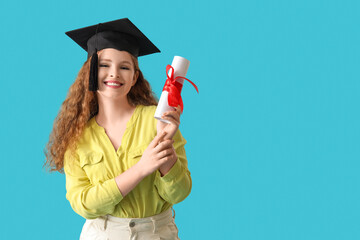 Happy female student in graduation hat and diploma on blue background