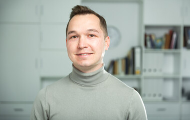 Portrait of smiling european man office manager looking at camera.