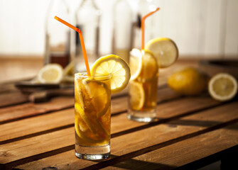 Refreshing iced tea with lemon slice on wooden table