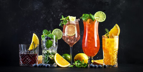 Assorted refreshing cocktails with citrus garnish