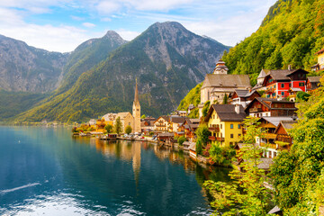 The picturesque lakefront townscape with homes and towers above the Tyrolian village of Hallstatt,...