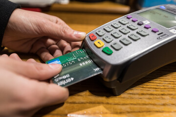 Close-up of hand entering pin on card machine