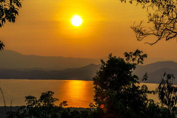 Wallpaper blurred nature of the twilight light in the evening by the large water basin surrounded by big trees, the integrity of the forest