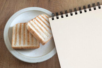 Sandwich recipe Blank. Mockup notepad on blurred background of plate with toast bread on table....