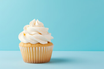 Simple birthday cupcake on a solid light blue background with empty space on the left