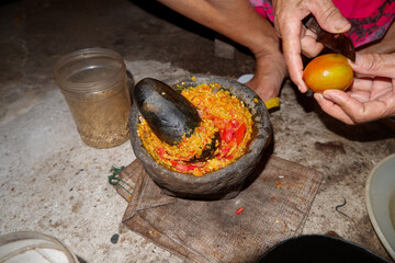 photo of pestle for chilies. food processing process for cooking