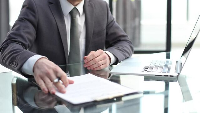 Businessmen in the office are talking and discussing documents in close-up