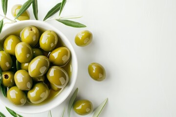 Salted olives and olive branches placed on a white background - obrazy, fototapety, plakaty