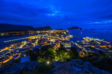 Twilight over coastal town with illuminated streets