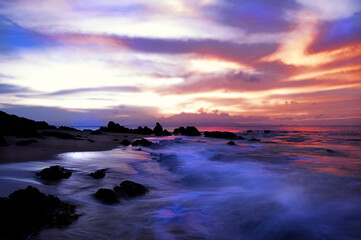 Majestic sunset at rocky beach