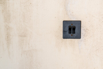 Old Grey Plastic Light Switch On Beige Abandoned Wall