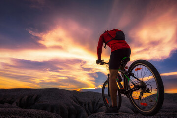 Sunset cycling adventure on rocky terrain