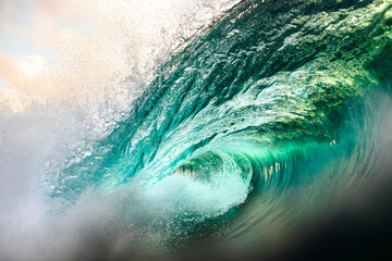 Close-up of a powerful turquoise wave cresting, highlighting the energy of the sea