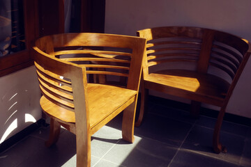wooden chairs exposed to morning light