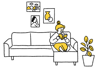 Woman reading a book on the living room sofa