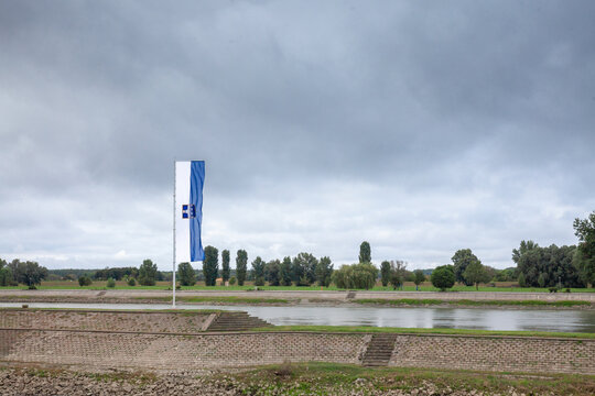 Osijek city flag with the coat of arms of the city in front of Osijek waterfront on drava river It's official visual & symbol of Osijek, one of the main cities of Slavonia, in Croatia, Central Europe.