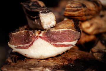 Selective blur on blocks of slanina, a serbian bacon, made of dried cured pork, smoked, on the stand of a countryside market of Serbia. It's a traditional meat product from Balkans.