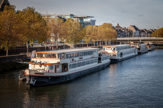 MAASTRICHT, NETHERLANDS - NOVEMBER 10, 2022: Dutch barge boats, called woonboot on Maastricht Waterfront on the Meuse Maas river in autumn. Maastricht is dutch city in netherlands in Limburg province.